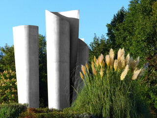 A decorative industrial-monument with reed in the public park. - obrazy, fototapety, plakaty