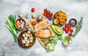 Grilled salmon steaks with pickled garlic and herbs.