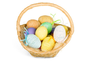Basket with colorful eggs isolated on white background