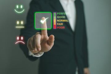 Customer service and Satisfaction concept ,Business people are touching the virtual screen on the happy Smiley face icon to give satisfaction in service. rating very impressed