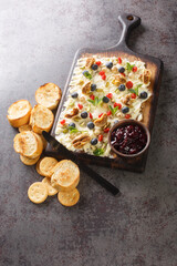 Sweet Butter board with dried cherries and figs, pistachios, hazelnuts, fresh blueberries and mint close-up on the table. Vertical top view from above