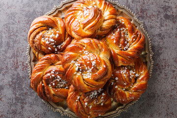 Homemade tasty Kanelbulle the nordic cinnamon rolls close-up on a plate on the table. Horizontal...