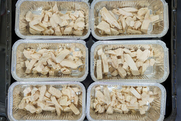 Raw chicken breast slices in baking tray ready for oven