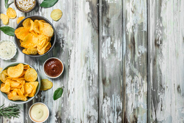 Potato chips with different sauces.