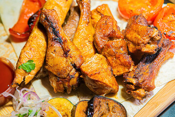 A selection of grilled gourmet meats on a rustic timber board.