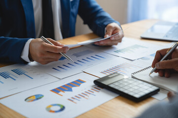 Portrait of a young Asian businessman calculating numbers and doing details and clarifying information. For investment in real estate projects planning ideas financial.