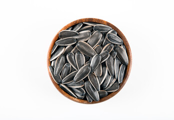 Black sunflower seeds in a bowl on white background,top view
