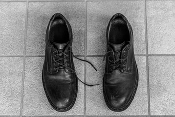 close-up of a brown shoes in the floor. Black and white shot.