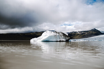 Many icebergs and ice floes in the glacial lagoon Fjalls&aacute;rl&oacute;n in iceland, which has broken away from the glacier tongue Fjallsj&ouml;kull. With a view of Hvannadalshn&uacute;kur in the background.