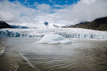 View of the glacier tongue Fjallsjökull with its icebergs and the glacier lagoon Fjallsárlón in Iceland. With a view of Öræfajökull in the background.