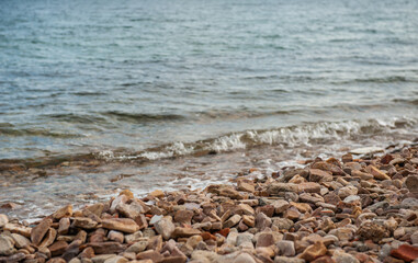 Sea background with pebbles and splash of water foam