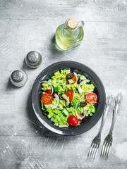 Vegetable salad. Salad of cucumbers, tomatoes and red onions with spices and olive oil.