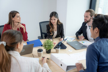 Group of employees brainstorming and teamwork in office.