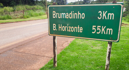highway sign indicating distance from cities, Brumadinho and Belo Horizonte, in Brazil