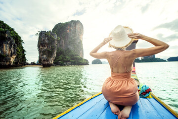Real photo of traveler woman on the long tail boat looking at the James Bond island Phuket, Thailand, Asia. Tourism destination. - obrazy, fototapety, plakaty
