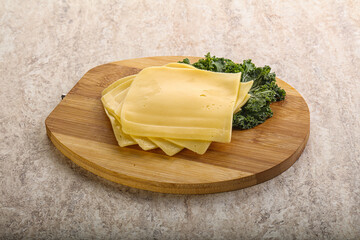 Sliced Gouda cheese over board