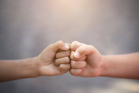 Fist bump together of kid hand from playing in life activity in cooperation. creative idea of working participate concept.