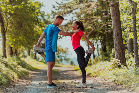 Couple enjoying in a healthy lifestyle warming up and stretching before jogging