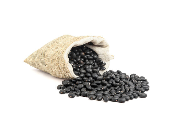 Black beans in burlap isolated on white background