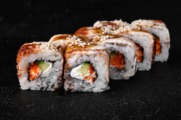 Eel sushi roll of fish black concrete background