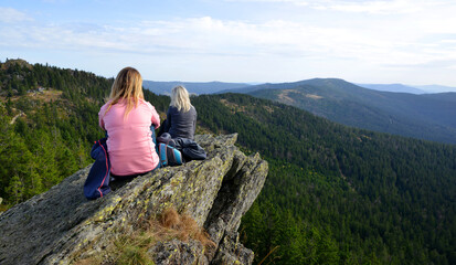 Two female tourists on the top of mountain Klein Osser in the National park Bayerischer Wald, Germany.