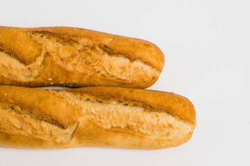 French baguettes on a white background with copy space. Delicious appetizing crust of a bun close-up
