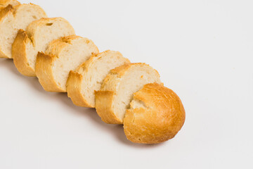 Pieces of crispy delicious French baguette on a white background