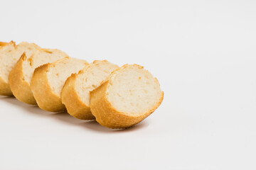 Pieces of crispy delicious French baguette on a white background