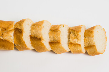 Appetizing French bun crust close-up. Sliced french baguette on a white background with space for text