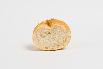 A piece of baguette with an appetizing crust, on a white background, macro. Concept of healthy eating.