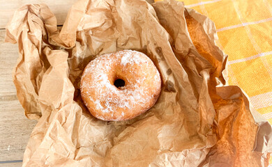 donut with icing sugar on baking paper.