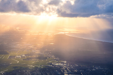 Sun rays shining through clouds above Amsterdam