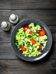 Vegetable salad. Salad of cucumbers, tomatoes and red onions with spices and olive oil.