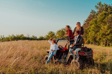 Group young happy people enjoying beautiful sunny day while driving a off road buggy car on...