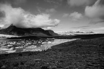 View of the glacier tongue Fjallsjökull with its icebergs and the glacier lagoon Fjallsárlón in Iceland. With a view of Öræfajökull in the background.