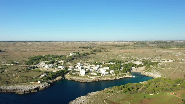 The fishing village of Porto Badisco and its port by the Adriatic Sea in Europe, Italy, Puglia, towards Lecce, in summer, on a sunny day.