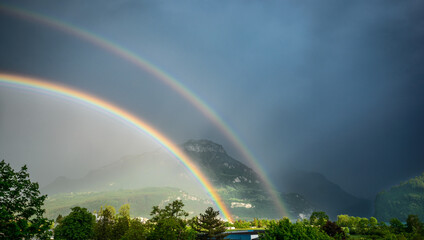 Double rainbow in the sky over the Alps in central Switzerland. Canton of Schwyz - 561306357