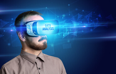 Businessman looking through Virtual Reality glasses, virtual security concept
