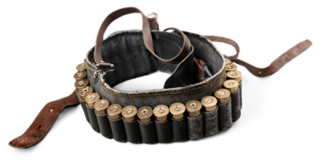 Old hunting cartridges and bandoleer on a wooden table