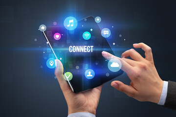 Businessman holding a foldable smartphone