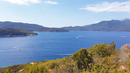Fototapeta na wymiar Seascape of Elba island with blue sea and hills. Panorama of the nature of the island of Elba.