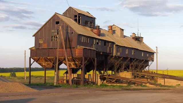 Volga region, harvest season. Mechanized threshing floor at the sunset light.