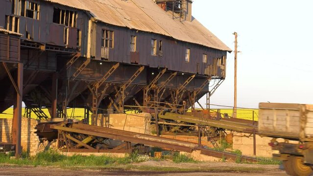 Volga region, harvest season. Mechanized threshing floor at the sunset light.