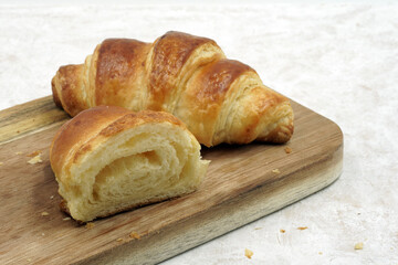 Delicious freshly baked croissants on the board.