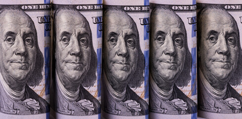 Fragments of US $ 100 bills with a portrait of Benjamin Franklin