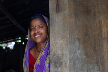Rural woman standing at door of house in indian village