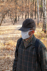 Man in cap and protective mask in nature