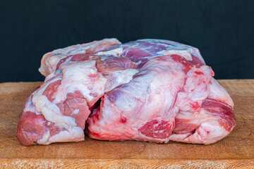 Raw mutton on wood. Meat concept photo on dark background.