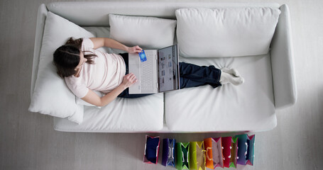 Online Laptop Shopper On Sofa