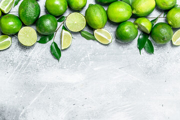 Cut and whole juicy lime with leaves.